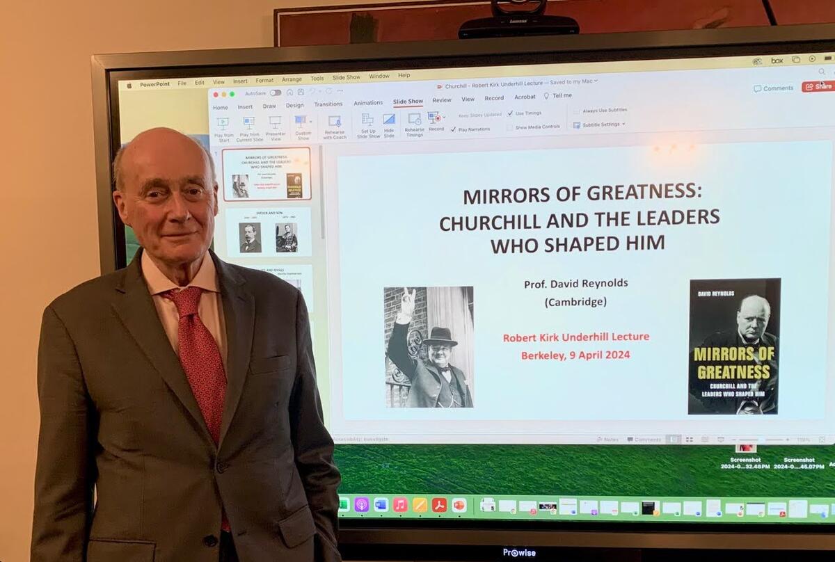 David Reynolds (Cambridge University) stands in front of his presentation for the 2024 R. Kirk Underhill Lecture